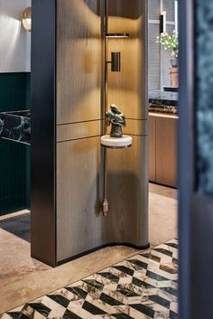 an open cabinet in the middle of a room with black and white tile flooring