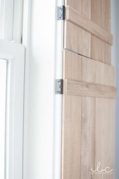 a close up of a wooden door with metal hardware on the bottom and side panels