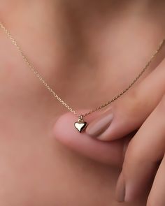 "This 14k solid gold tiny heart necklace would be the ideal valentine's day gift to show her your love. She will never want to take this small heart gold minimalist necklace off her neck. * The thickness of the cable chain: 1 mm * At the time of purchase, you can choose the chain length as 16\" (40 cm), 18\" (45 cm) or 20\" (50 cm). * You can choose one of the colors yellow gold, white gold or rose gold. The color of the necklace used in the photos is yellow gold. * Temiroglu Gold products are real solid gold. It is definitely not gold plated, not gold filled. * All products are presented to you in high quality jewelry boxes. * Depending on your request, we can provide delivery in the form of a gift package. Express Shipping Process    * United States: 4-6 business days    * Canada: 4-6 bu Fine Jewelry Heart Necklace With Delicate Chain As Gift, 14k Gold Heart Charm Necklace For Her, 14k Gold Heart Charm Necklace As Gift For Her, Simple 14k Gold Jewelry With Heart Charm, Minimalist Jewelry With Heart Charm, Minimalist Heart Charm Jewelry, Tiny Minimalist Open Heart Jewelry, 14k Gold Heart Charm Necklace, Gift For Her, Dainty Heart Cut Charm Necklace For Valentine's Day