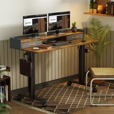 two computer monitors sitting on top of a wooden desk