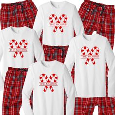 the moms pajamas are red and white with candy canes on them, along with two matching ones