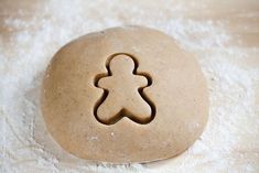 a cookie shaped like a man on top of flour