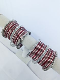 Personalize your style with customizable bangles, crafted to reflect your unique taste. Choose your colors, designs, and embellishments for a truly one-of-a-kind accessory. Traditional Stackable Bangle For Festive Occasions, Handmade Adjustable Bollywood Bangle, Traditional Beaded Bangle For Celebration, Traditional Stackable Bracelets For Party, Adjustable Silver Bollywood Bangle, Bohemian Red Bracelets For Diwali, Silver Bollywood Bangle As Gift, Bollywood Style Silver Bangle Gift, Adjustable Bollywood Style Bracelet Hand Set