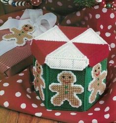 two gingerbread houses on a red and white polka dot blanket