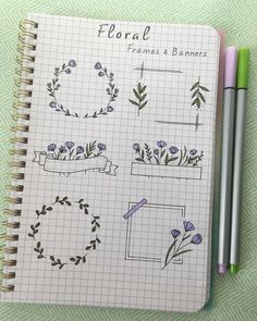 a notebook with some flowers on it next to two markers and a pencil in the middle