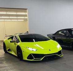 two lambs are parked in a garage next to each other and one is yellow