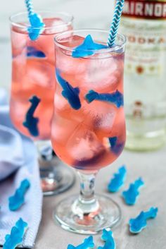 two glasses filled with pink and blue liquid