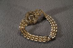 I am offering this fabulous vintage yellow gold tone bracelet. This piece is truly gorgeous, and it has the following features: * beautiful vintage bracelet * line link * stackable * faux pearl * rhinestone * bib style * 7 inches in length This is a fantastic and classic piece. There is tons of sparkle and shine with this piece. It will beautifully complement your upcoming fashion season. Buyer pays all shipping and handling. Vintage Jeweled Gold Bracelets, Vintage Gold Jeweled Bracelets, Vintage Gold Bracelet For Wedding, Vintage Gold Jewelry With Rhinestones, Victorian Gold Jeweled Bracelets, Antique Gold Jewelry With Rhinestones, Victorian Gold Bracelets For Party, Vintage Round Bracelet With Jewels, Formal Gold Jeweled Bracelets