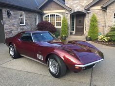 a red sports car parked in front of a house