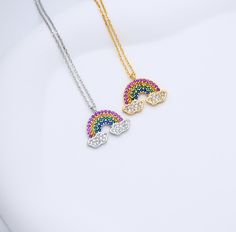 Add a burst of joy and positivity to your style with this vibrant Rainbow Necklace. Perfect for those who love colorful, uplifting jewelry, this necklace serves as a beautiful reminder of hope, happiness, and the beauty of diversity. 🌈✨ Finish: Gold Dipped * White Gold Dipped Adjustable Chain 16.5 to 17.5 inches Pendant Size: 2cm*1.6cm This necklace is ready to ship in 1 - 3 business days To ensure lasting beauty and shine, follow these simple care instructions: * Avoid Contact with Water: Remove your necklace before swimming, showering, or participating in water-related activities. * Avoid Harsh Chemicals and Clean Gently: If your necklace needs cleaning, use a soft, damp cloth to gently wipe away any dirt or oils. Avoid abrasive materials that could scratch the delicate gold surface. * Casual Rainbow Necklace, Cheap Personalized Rainbow Necklaces, Adjustable Rainbow Necklace, Heart-shaped Rainbow Necklace For Gift, Rainbow Necklaces With Heart-shaped Beads, Pride Necklace, Rainbow Necklace, Rainbow Jewelry, Gold Dipped