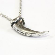 My engraved wolf claw necklace, originally cast from a real North American Grey Wolf in solid sterling silver. Measuring 1-1/4", this one came from a large specimen, they're not usually this big. Beautifully scroll engraved on both sides, as well as the front curve, making this ornately sculptured wolf claw the nicest that you'll find. No bail or jump ring is needed, the chain passes directly though a hole that I carefully bore through the knuckle, just like the Native Americans did in the old d Hand Cast Claw Necklace As Gift, Hand Cast Claw Necklace For Gift, Viking Style Engraved Sterling Silver Jewelry, Unique Claw Shaped Silver Necklace, Unique Claw-shaped Silver Jewelry, Viking Style Engraved Jewelry For Collectors, Viking Style Engraved Sterling Silver Necklace, Unique Silver Claw Necklace, Viking Style Engraved Jewelry Collectible