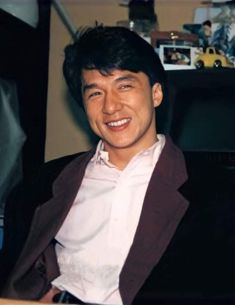 a man sitting in a chair smiling at the camera