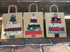 three bags with different designs on them sitting next to a brick wall and some bricks