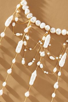 A stunning display of freshwater pearls, this choker necklace features a string of pearls that elegantly encircle the neck. Below, elongated droplets and draped strands intertwine gracefully, creating a lustrous and eye-catching statement piece. | Waterfall Pearl Choker Necklace by Anthropologie in Gold, Women's, Gold/Plated Brass/Freshwater Pearl Statement Beaded Necklace, Pearl Drop Necklace For Party, Luxury Pearl Choker Necklace, Lariat Pearl Necklace With Charm For Parties, Elegant Beaded Drop Necklace, Elegant Beaded Pearl Necklace With Dangle, Elegant Multi-strand Necklace With Dangling Beads, Elegant Drop Necklace With Dangling Beads For Party, Elegant Pearl Necklace With Dangling Beads For Wedding