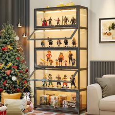 a living room with a christmas tree in the corner and toy figures on top of it