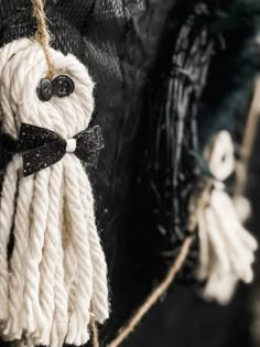 there is a white rope with a black bow on it and some tassels