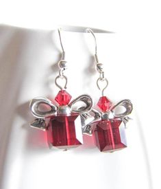 Beautiful, red cube beads are topped with a silver plated bow just like a Christmas present. Give the Christmas spirit as a gift or keep the earrings for yourself! Great as stocking suffer too! The earrings are 1.25in long (3.5cm) with Surgical steel fishhook earwire. For larger selection you can visit my shop: http://www.etsy.com/shop/EvaLineJewelry?ref=si_shop Holiday Gift Dangle Earrings, Holiday Dangle Earrings For Gifts, Dangle Earrings As Holiday Gifts, Dangle Earrings For Holiday Gift, Red Christmas Jewelry Gift, Red Jewelry Christmas Gift, Red Jewelry For Christmas Gift, Holiday Dangle Jewelry Gift, Holiday Dangle Jewelry For Gifts