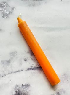 an orange carrot laying on top of a marble counter