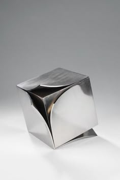 a silver object sitting on top of a white table