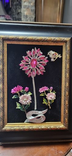 a framed painting with flowers and butterflies on it