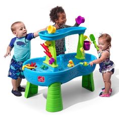 two children playing in a water table with toys