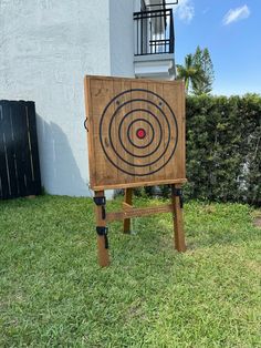 a wooden target board sitting in the grass