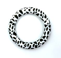 a black and white animal print ring on a white background