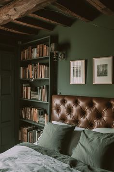 a bedroom with green walls and leather headboard