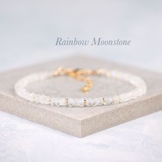 Beautiful natural Rainbow Moonstone gemstones are interspersed with your choice of tiny Gold Vermeil or Sterling Silver beads in this elegant bracelet. The Rainbow Moonstone beads are entirely natural and feature plenty of the mesmerising adularescence (blue flash) for which this gemstone is so loved. - Completely natural genuine gemstones measure approx. 3.5-4.5mm - Bracelet extends from 6.5-8 inches (custom sizes available on request) - Packaged in a gift box with gemstone information card ready for gifting or treating yourself - Choose from Gold Fill or 925 Sterling Silver The Rainbow Moonstone beads feature mesmerising blue flashes, and are a faceted rondelle shape with excellent sparkle. A birthstone for the month of June, Rainbow Moonstone is a magical looking stone, with internal gl Moonstone Bracelets With Natural Stones As Gift, Moonstone Gemstone Beaded Bracelet As Gift, Minimalist Crystal Bracelet With Natural Stones, Dainty White Gemstone Beads Bracelet, Adjustable Moonstone Gemstone Bead Bracelet, Adjustable Moonstone Bracelet With Gemstone Beads, Gift Moonstone Crystal Bracelet With Natural Stones, Moonstone Crystal Bracelet With Gemstone As Gift, Gold Beaded Bracelets With Moonstone