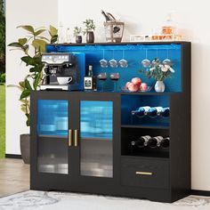 a black and blue cabinet with wine glasses on it's doors, next to a potted plant