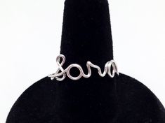 Wire wrapped name rings. Any short name or word - Up to 5 letters. Can also use hearts - they count as 1 letter. lower case letters - lower case works best with these rings. Comes in silver or gold colored non tarnish artistic wire. They are formed freehand by me and each one is unique and individualized. They do have some flexibility, so please be careful when wearing them. Please allow 1 to 2 days for your piece to be completed and on its way to you. Packaged with care and comes in a gift box. Personalized Adjustable Open Midi Rings, Custom Name Adjustable Open Ring, Adjustable Rings With Custom Text For Gifts, Custom Text Adjustable Rings As Gifts, Custom Text Adjustable Rings For Gifts, Trendy Personalized Adjustable Rings, Personalized Adjustable Initial Open Ring, Personalized Initial Open Ring, Personalized Adjustable Open Initial Ring