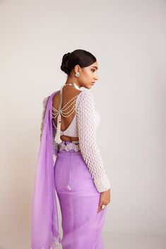 Lilac pearl embellished saree paired with pearl drop full sleeves blouse.From Vvani Vats Jhoomar collection.DELIVERY TIMEPlease allow 8-12 weeks for your outfit to arrive.FABRIC DETAILSBlouse - Georgette, Saree - OrganzaProfessional cleaning only. DISCLAIMERBelts are additional chargeable. Hanging tassel at back is additional chargeable. Diwali Blouse Piece With Pearl Embroidery For Saree, Diwali Saree Blouse Piece With Pearl Embroidery, Designer Long Sleeve Pre-draped Saree For Eid, Silk Long Sleeve Pre-draped Saree With Zari Work, Designer Pearl Embroidery Fitted Saree, Pearl Embroidered Blouse For Reception, Long Sleeve Georgette Blouse For Reception, Festive Long Sleeve Blouse With Pearl Embroidery, Designer Silk Saree With Pearl Embroidery