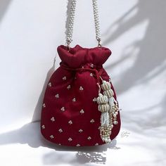 Elevate your bridal ensemble with our exquisite deep red Bridal Wedding Day Potli Bag. Crafted from luxurious raw silk fabric, adorned with intricate zardozi and beadwork, this potli bag exudes elegance and opulence. The delicate beadwork on both side of bag adds a touch of glamour, while the beautiful log tassels enhance its regal charm. This potli bag is the perfect accessory to complement your bridal look, adding a timeless allure to your special day. Product Details: *Handmade with traditional Pakistani and Indian techniques *Spacious interior  *Measures 7 inches To explore additional styles, kindly visit our website at dulhansdiary.etsy.com. . . . . . . #deepredpotli #handmadeclutch #bridalhandbag #weddingaccessories #ethnicbag #uniquegift #artisanmadeclutch #punjabiclutches #potlibag Indian Potli Bags, Festive Beaded Evening Bag As Gift, Festive Beaded Evening Bag For Gift, Elegant Beaded Clutch For Festivals, Red Shoulder Bag For Festive Gift, Festive Red Shoulder Bag As Gift, Festive Red Shoulder Bag For Gifts, Beaded Pouch Potli Bag As Gift, Beaded Potli Bag Pouch For Gifts