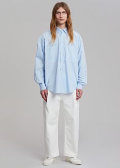 Color: Blue Crisp cotton poplin Oversized fit Pointed collar Double breast pockets Curved hem Button front closure Button cuffs 100% Cotton Dry Clean Imported One Size Product Measurements: 23" Shoulder 57" Chest 31" Length Model is 187cm/ 6'1" wearing size M Oversized Shirt, Cotton Poplin, Oversized Fits, Double Breasted, Lab Coat, Color Blue, Dry Clean, Collar, Women's Top