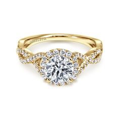 a yellow gold engagement ring with a round diamond center