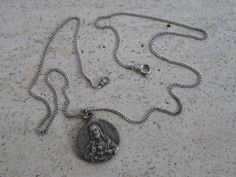 Religious antique French silver ( MARKED ) chain necklace with silver ( MARKED ) medal pendant charm of Holy Mary and Holy Christ. I bought the chain on a brocante ( fleamarket ) ( Lille ) in France. Measures of the chain : 18 inches ( 45 cm ) Measures of the medal ; 0,87 x 0,95 inches ( 2,03 x 2,43 cm ) If you don't have paypal you can pay by bank transfer. Registered shipping is possible. For other pictures or information do not hesitate to contact me. I deliver all over the world. Vintage Round Miraculous Medal Necklace, Vintage Necklace With Round Miraculous Medal, Vintage Round Necklace With Miraculous Medal, Vintage Miraculous Medal Necklace, Vintage Necklaces With Miraculous Medal, Vintage Silver Necklace With Miraculous Medal, Vintage Medallion Necklace With Silver Chain, Our Lady Of Sorrows, Z Photo