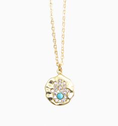 Our Hamsa symbol necklace is a powerful talisman to protect against evil and bring good fortune. This talisman has been around for centuries and is believed to protect against evil and bring good luck. The five fingers of the Hamsa hand represent the five elements, creating a symbol of balance and harmony that's perfect for anyone who values positivity and spirituality.
Length: 18" gold filled chainPendant size: 15mm gold plated charm Blessing Amulet Necklace With Coin Pendant, Blessing Amulet Style Necklace With Coin Pendant, Symbolic Good Luck Coin Pendant Necklace, Spiritual Good Luck Necklace With Round Shape, Good Luck Spiritual Necklace With Round Shape, Spiritual Round Good Luck Necklaces, Blessing Medallion Charms Jewelry, Spiritual Good Luck Round Necklace, Spiritual Medallion Pendant Necklace With Charms