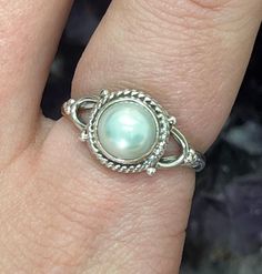 This listing is for a single 925 Wishbone Design Pearl Sterling Silver Ring. A few options are pictured to show the natural variation in the stone. Mother Of Pearl comes from a mollusk shell that produces the inner layer of shell. Usually, the material is strong and has a white hue. It is known for its iridescent rainbow that shows different colors depending on the angle. Mother Of Pearl is the same material as the outer coating of Pearls. Mother Of Pearl helps to focus ones attention to bring t Fine Jewelry Sterling Silver Pearl Ring With Oval Shape, Oval Sterling Silver Pearl Ring With Gemstone, Oval Sterling Silver Pearl Ring, Fine Jewelry Oval Pearl Ring In Sterling Silver, Oval Sterling Silver Pearl Ring In Fine Jewelry Style, Cabochon Pearl Ring In Sterling Silver, Silver Pearl Ring With Gemstone In Sterling Silver, Oval Sterling Silver Hallmarked Pearl Ring, Classic Sterling Silver Pearl Ring With Gemstone