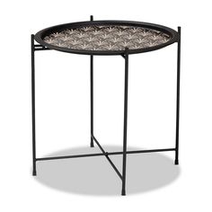 a round table with black metal frame and flower designs on it