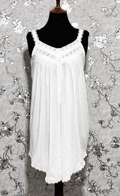 This gorgeous sleeveless Victorian nightgown is made entirely of cotton for the utmost in comfort and softness. It perfectly embodies the beauty and elegance of the Victorian era, embellished with exquisite lace accents. A hint of vintage charm can be added to your evening routine with this dreamy, timeless style created by the lightweight fabric and exquisite lace details. Elegant Cotton Summer Sleepwear, Elegant Summer Cotton Sleepwear, Elegant Cotton Sleepwear For Summer, Summer Sleeveless Nightgown With Lace Trim, Sleeveless Lace Trim Nightgown For Summer, Sleeveless Summer Nightgown With Lace Trim, Casual Sleeveless Nightgown With Lace Trim, Casual Sleeveless Lace Trim Nightgown, Cotton Nightgown For Spring Relaxation