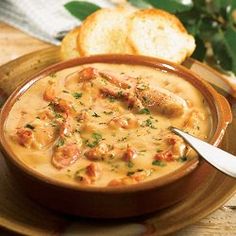 a bowl of soup with bread on the side