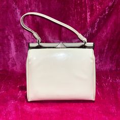 D E S C R I P T I O N This Is A 1950's Cream Colored Patent Leather A Frame Bag With Gold Tone Hardware. Ridged Golden Triangle Push Clasp. This Is In Good Vintage Condition Some Signs Of Wear Are Evident: Minor Scratches On The Patent Leather, And Some Separation To Bottom Corners Inner Crease. M E A S U R E M E N T S Bag Width: 4.5” Bag Height: 8” Bag Length: 9” Authenticity Guarantee All Bags Sold In Our Shop Are 100% Guaranteed Authentic Or Your Money Back. Vintage White Handheld Shoulder Bag, Vintage White Top Handle Shoulder Bag, Vintage White Rectangular Bag, White Vintage Rectangular Bag, White Rectangular Vintage Bag, Elegant White Bags With Snap Closure, Retro Beige Satchel With Detachable Strap, Vintage Square Evening Bag For Formal Occasions, Beige Retro Satchel With Detachable Strap