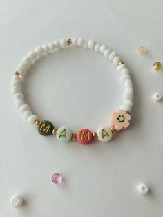 MAMA bracelet.  Perfect for stacking together with other bracelets or wearing separately.  Approximately 6.75 inches, could be made bigger or smaller, just send me a message.  Beads are 4mm, white and gold. 6mm Letter beads, colors will vary but we will try our best to have alternating colors. Mama Stack Bracelets, Mom Bead Bracelets, Mama Bracelet Beads, Mom Bracelet Ideas, Beaded Bracelet Words, White Adjustable Bracelets For Mother's Day, Adjustable White Bracelets For Mother's Day, Mother's Day White Bracelets With Letter Beads, Handmade White Beaded Bracelets For Mother's Day