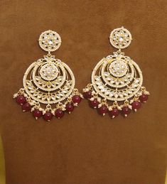 Metal = Gold Plated Occasion = Wedding ,Party Wear, Bridal Color = White and Red Size = Earrings Size - 3.5 Inches(approx) Closure = Screw Back 100% Satisfaction Guarantee: 1 Year Warranty, Long Lasting Plating, High-Quality Stones Occasion: Perfect choice for any Indian occasion. Care: It is advisable that you keep products away from direct heat, humidity, and moisture. It is best to preserve your jewelry in the box. Keep Away From Water, Spray And Perfumes For Better Look. Free Shipping Worldw Meenakari Earrings For Marriage And Festivals, Festive Intricate Design Earrings For Wedding, Festive Wedding Earrings With Intricate Design, Festive Kundan Earrings For Marriage, Chandbali Earrings For Marriage On Diwali, Chandbali Earrings For Marriage And Diwali, Festive Chandbali Earrings For Marriage, Wedding Chandbali Earrings For Diwali, Festive Meenakari Earrings For Marriage