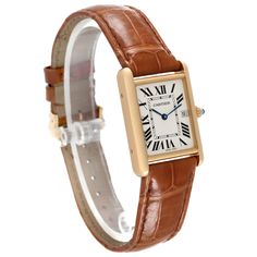 Cartier Tank Louis Yellow Gold Brown Leather Strap Mens Watch W1529756 Card. Quartz movement. 18k yellow gold case 25.0 x 33.0 mm. Circular grained crown set with a blue sapphire cabochon. . Scratch-resistant mineral crystal. Silvered opaline dial with black Roman numeral hour markers and an inner minute track. Sword-shaped blue hands. Date calendar at 3 o'clock aperture. Secret Cartier signature at VII. Brown leather strap with 18K yellow gold tang buckle. Cartier Tank Louis, Tank Watch, Sapphire Cabochon, Amazing Watches, Used Watches, Cartier Tank, Roman Numeral, Brown Leather Strap, Gold Case