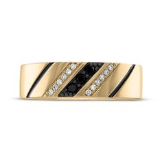 a gold ring with black and white diamonds