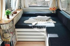 the inside of a small camper with storage drawers and shelves in front of it