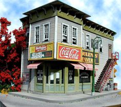 a model of a building with coca cola signs on the front and stairs leading up to it