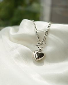 Embrace your edgy side with this sterling silver heart choker necklace, designed for those who love bold, punk-inspired accessories. Featuring a durable chain and a striking heart pendant, this choker is both stylish and practical, perfect for making a statement whether you're out on the town or at the beach. The waterproof design ensures that this piece can withstand the elements, making it an ideal choice for daily wear or any adventure. Add a rebellious touch to your jewelry collection with this unique, high-quality choker. Trendy Silver Heart Chain Necklace, Trendy Silver Heart Necklace With Lobster Clasp, Edgy Heart Pendant Necklace For Gift, Edgy Silver Jewelry With Heart Charm, Edgy Heart Pendant Necklace As Gift, Silver Heart Choker Necklace With Chain, Silver Heart Necklace With Chunky Chain For Gifts, Trendy Silver Heart Necklace With Chunky Chain, Edgy Heart-shaped Silver Jewelry