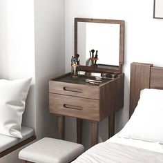 a bedroom with a bed, mirror and stool